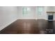 Spacious living room with hardwood floors, a fireplace, and bright natural light coming in through multiple windows at 911 Balsam Ter, Charlotte, NC 28214