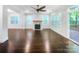 Open living room features a fireplace, hardwood floors, large windows, and access to an outdoor deck at 911 Balsam Ter, Charlotte, NC 28214