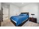 Bedroom featuring modern design, a large bed with denim comforter and a bedside table at 9823 Oaklawn Nw Blvd, Huntersville, NC 28078