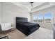 Bright primary bedroom featuring modern decor, a dark bed frame, and a ceiling fan at 9823 Oaklawn Nw Blvd, Huntersville, NC 28078