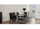 Dining area features a modern table and chairs with hardwood floors and a window view at 9823 Oaklawn Nw Blvd, Huntersville, NC 28078