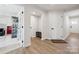 Welcoming entryway with hardwood floors and white doors showcases the home's modern style at 9823 Oaklawn Nw Blvd, Huntersville, NC 28078