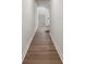 Hallway with hardwood floors leads to stairs, showing the entry's bright, clean design at 9823 Oaklawn Nw Blvd, Huntersville, NC 28078