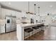Modern open kitchen with large island, stainless steel appliances, and hardwood floors at 9823 Oaklawn Nw Blvd, Huntersville, NC 28078