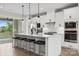 Modern kitchen with white cabinets, a large island, and stainless steel appliances at 9823 Oaklawn Nw Blvd, Huntersville, NC 28078