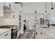Bright kitchen with stainless steel appliances, white cabinets, and an open view to the living area at 9823 Oaklawn Nw Blvd, Huntersville, NC 28078
