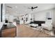Bright open-concept living room with modern furnishings, an island kitchen, and natural light at 9823 Oaklawn Nw Blvd, Huntersville, NC 28078