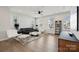 Contemporary living room with ample natural light, modern furnishings, and hardwood floors at 9823 Oaklawn Nw Blvd, Huntersville, NC 28078
