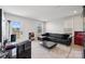 Modern living room features a black leather sectional, a large window, and neutral decor at 9823 Oaklawn Nw Blvd, Huntersville, NC 28078