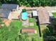 Aerial view of a home with a fenced yard, pool, outbuildings, and mature trees at 1005 Caldon Dr, Stanley, NC 28164