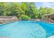 Fenced backyard featuring a pool, deck, and shed at 1005 Caldon Dr, Stanley, NC 28164