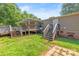 Large backyard featuring a deck, grassy lawn, and mature trees at 1005 Caldon Dr, Stanley, NC 28164