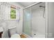 A bright bathroom features a glass shower and natural light at 1005 Caldon Dr, Stanley, NC 28164