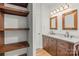 A bathroom features a double sink vanity and a set of shelves at 1005 Caldon Dr, Stanley, NC 28164