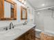 A bathroom features a double sink vanity and a glass-enclosed shower at 1005 Caldon Dr, Stanley, NC 28164
