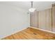 An empty bedroom shows wood-look floors and partial wood paneling at 1005 Caldon Dr, Stanley, NC 28164