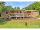 Cozy home boasts covered porch, wooden railings, and well-maintained landscaping at 1005 Caldon Dr, Stanley, NC 28164