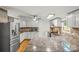 Bright kitchen features white cabinets, stainless steel appliances, granite countertops, and modern fixtures at 1005 Caldon Dr, Stanley, NC 28164