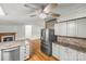 Open floor plan showing stainless steel appliances, island and living room with fireplace at 1005 Caldon Dr, Stanley, NC 28164