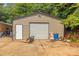 Metal outbuilding with a roll up door and side entry door with a concrete pad at 1005 Caldon Dr, Stanley, NC 28164