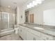 Modern bathroom featuring granite countertops, double sinks, a glass shower, and neutral tile at 1026 Kirby Dr, Fort Mill, SC 29715