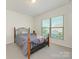 Bedroom with an iron bed frame and neutral carpet with great natural light at 1026 Kirby Dr, Fort Mill, SC 29715