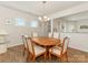 Dining room with seating for six, wood floors, and natural light filtering through the windows at 1026 Kirby Dr, Fort Mill, SC 29715