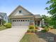 Charming single-Gathering home with a two-car garage, manicured landscaping, and a welcoming front facade at 1026 Kirby Dr, Fort Mill, SC 29715
