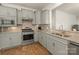 Galley kitchen with stainless steel appliances, gray cabinets, granite countertops, and a stainless steel faucet at 1026 Kirby Dr, Fort Mill, SC 29715