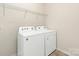 Convenient laundry area featuring a side-by-side washer and dryer and wire shelving at 1026 Kirby Dr, Fort Mill, SC 29715