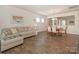 Open-concept living area features wood floors, a cozy couch, and easy access to dining area at 1026 Kirby Dr, Fort Mill, SC 29715