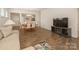 Bright living room with wood floors, a cozy couch, adjacent to a dining area and kitchen at 1026 Kirby Dr, Fort Mill, SC 29715