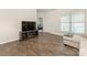 Bright living room with wood floors and a entertainment center featuring an electric fireplace at 1026 Kirby Dr, Fort Mill, SC 29715