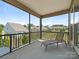 Relaxing screened patio with an outdoor lounge chair and neighborhood views at 1026 Kirby Dr, Fort Mill, SC 29715