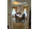 Formal dining room with a large table, six chairs, and large windows with decorative draperies at 1165 Mt Moriah Church Rd, China Grove, NC 28023