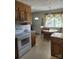 Cozy kitchen with wood cabinetry, white appliances, an eat-in area, and natural light at 1165 Mt Moriah Church Rd, China Grove, NC 28023