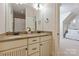Well-lit bathroom showcasing a double vanity and an open doorway into another room at 1304 Lookout Cir, Waxhaw, NC 28173