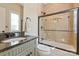 Cozy bathroom featuring a shower with glass doors and granite countertops at 1304 Lookout Cir, Waxhaw, NC 28173