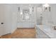 Bright bathroom showcasing double vanities, marble countertops, and a walk-in shower at 1304 Lookout Cir, Waxhaw, NC 28173