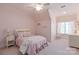 Charming pink bedroom featuring a cozy bed, soft lighting, and a quaint window seat at 1304 Lookout Cir, Waxhaw, NC 28173