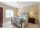 Comfortable bedroom with a decorative metal bed frame, lamps, and a large window at 1304 Lookout Cir, Waxhaw, NC 28173