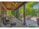 Covered patio with a swing, fireplace and outdoor seating, perfect for relaxation at 1304 Lookout Cir, Waxhaw, NC 28173