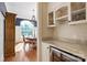 Transitional dining room with hardwood floors, chandelier, hutch, and adjacent wine bar at 1304 Lookout Cir, Waxhaw, NC 28173