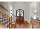 Stunning foyer featuring hardwood floors, a decorative staircase, and an arched doorway at 1304 Lookout Cir, Waxhaw, NC 28173