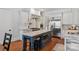 Gourmet kitchen with stainless steel appliances, gas range, custom vent hood, and center island with seating at 1304 Lookout Cir, Waxhaw, NC 28173