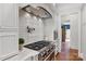 Chef's kitchen featuring a gas range, custom vent hood, subway tile backsplash, and granite countertops at 1304 Lookout Cir, Waxhaw, NC 28173