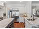 This beautifully updated kitchen has granite countertops, stainless appliances and white cabinets and lots of natural light at 1304 Lookout Cir, Waxhaw, NC 28173