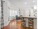 Bright eat-in kitchen area with a round table, wood floors, white trim, and plenty of natural light at 1304 Lookout Cir, Waxhaw, NC 28173