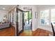Inviting interior leading to the outdoor living space, with an open door, stone patio, and landscaped greenery at 1304 Lookout Cir, Waxhaw, NC 28173