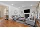 Cozy living room with fireplace, hardwood floors, and stylish decor, perfect for relaxation and gatherings at 1304 Lookout Cir, Waxhaw, NC 28173
